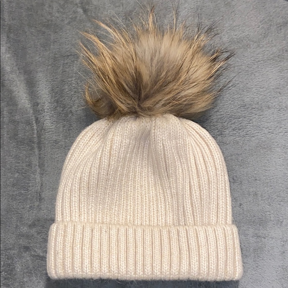 Hat with fur puff